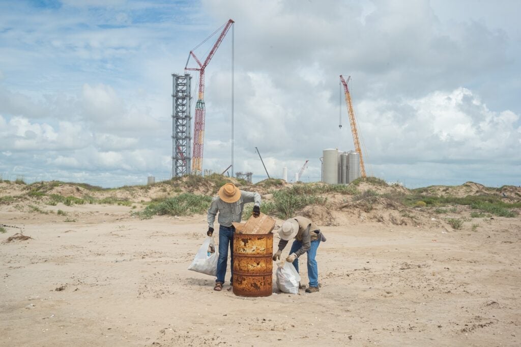 Boca Chica beach cleanup with SpaceX construction in background